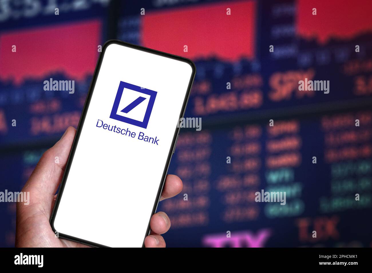 Smartphone with Deutsche Bank logo in hand on background of Stock