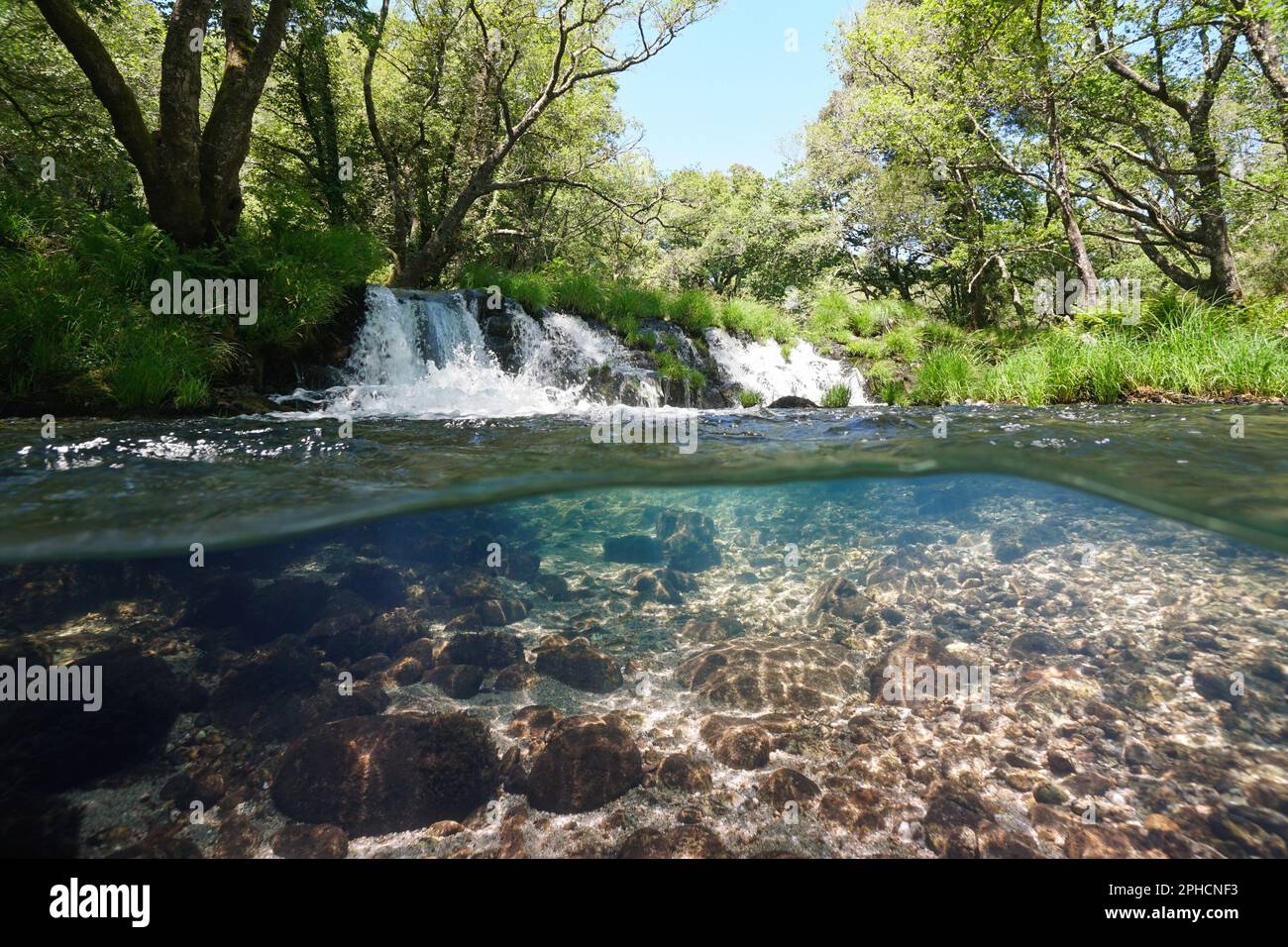 Cascade on a river over and under water surface, split level view, Spain, Galicia, Rio Verdugo Stock Photo