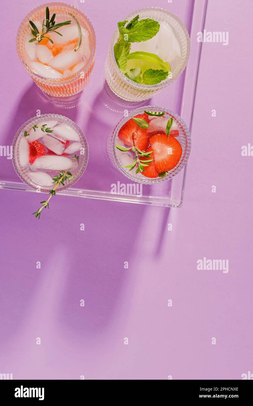 Summer refreshing drinks in a plastic tray on the purple background, top view Stock Photo
