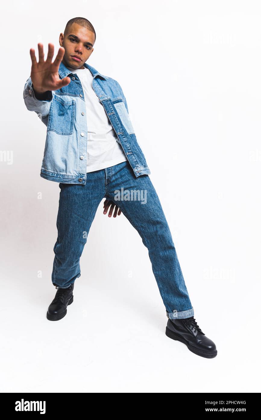Handsome man posing in the white studio dressed in blue denim wear. High quality photo Stock Photo