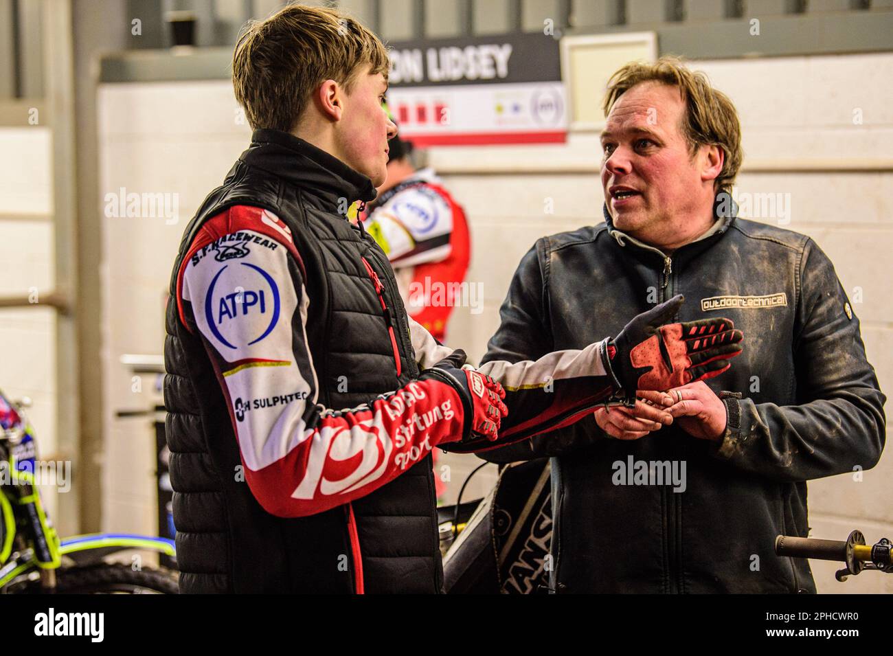 Manchester, UK. 27th March, 2023. Norick Blodorn (left) chats with his mechanic during the SGB Premiership match between Belle Vue Aces and Sheffield Tigers at the National Speedway Stadium, Manchester on Monday 27th March 2023. Credit: MI News & Sport /Alamy Live News Stock Photo