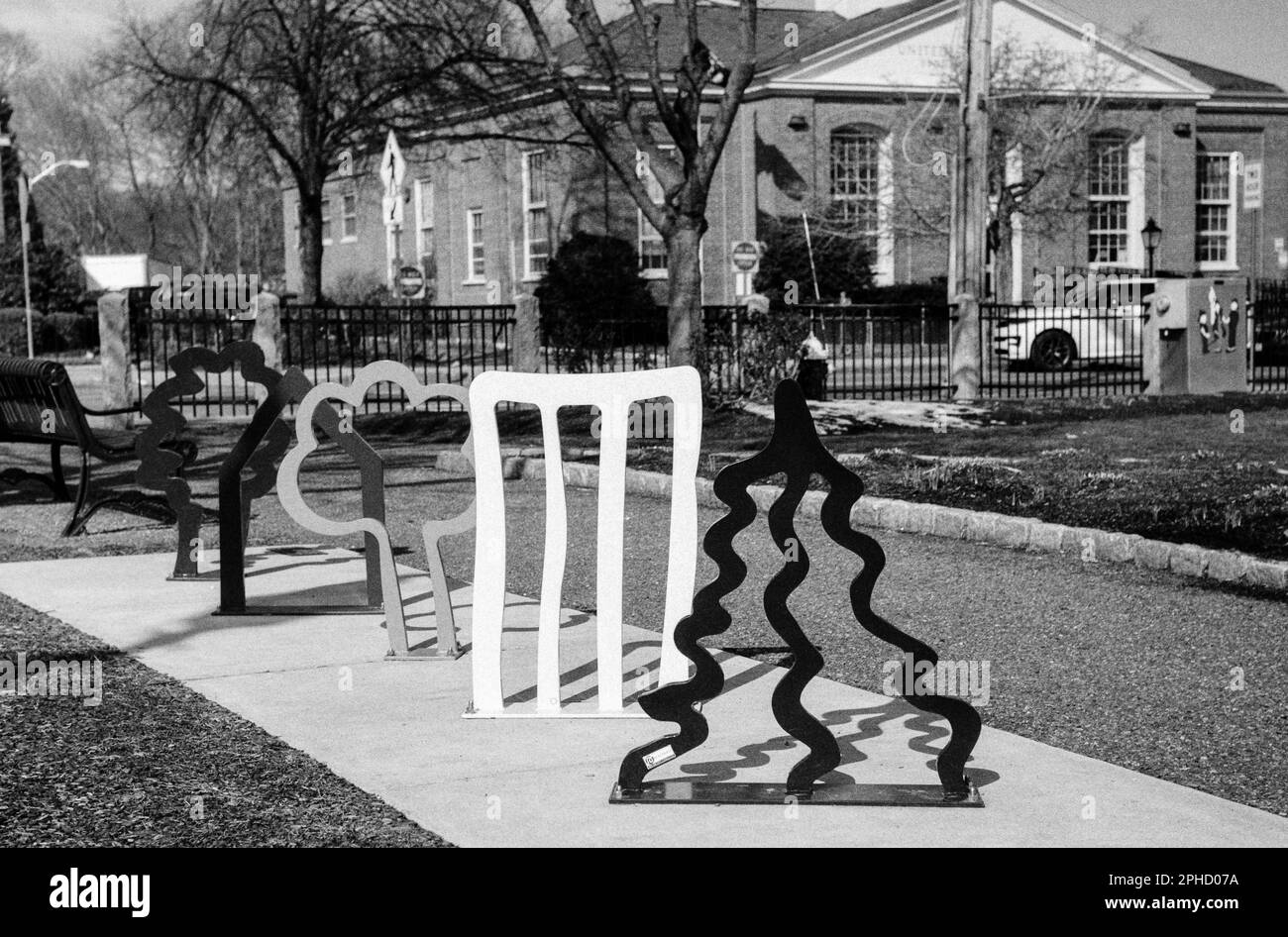 A metal sculpture mounted in concrete runs through the town common in