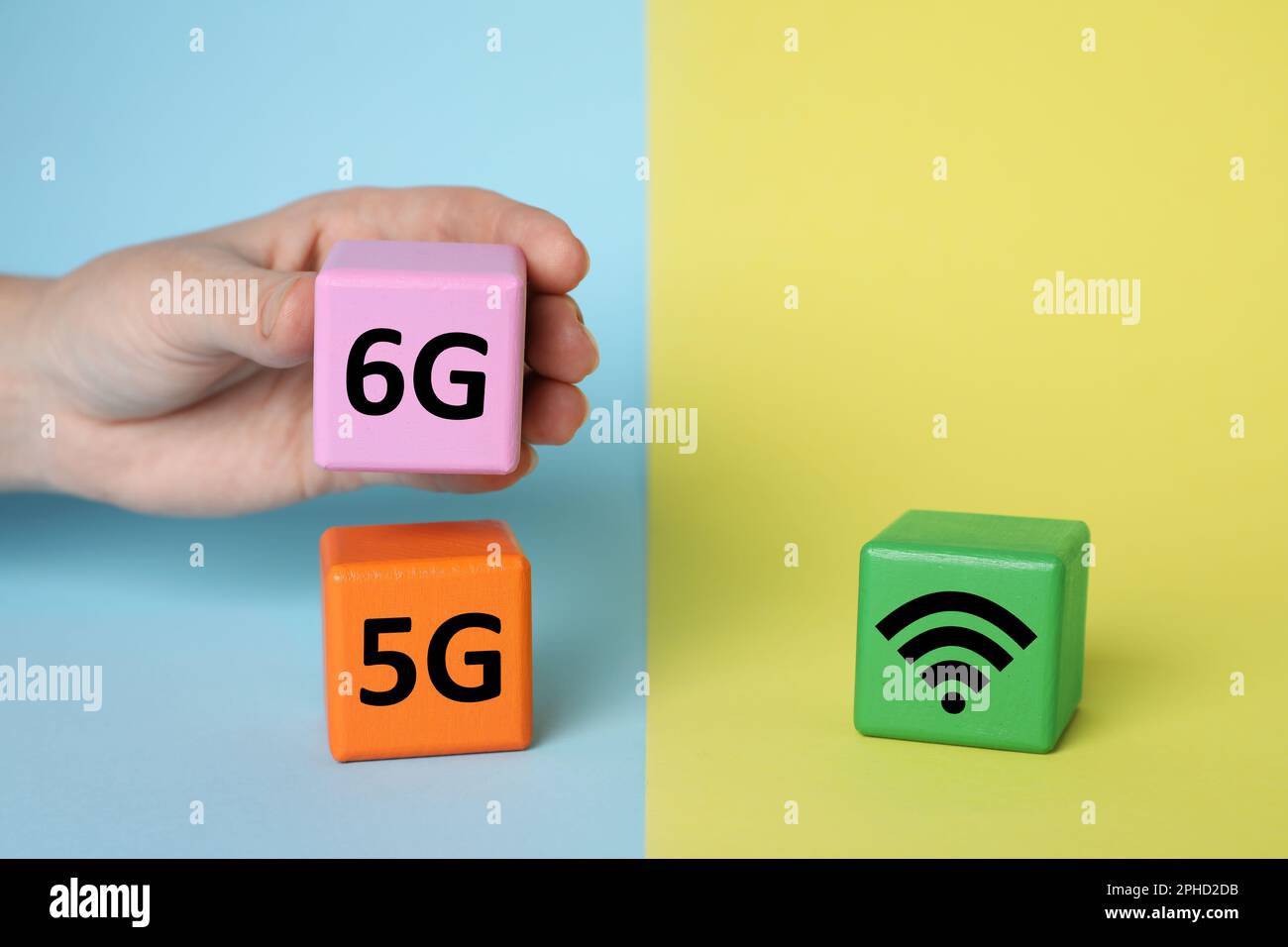 Man putting 6G instead 5G near WiFi sign on color background, closeup Stock Photo