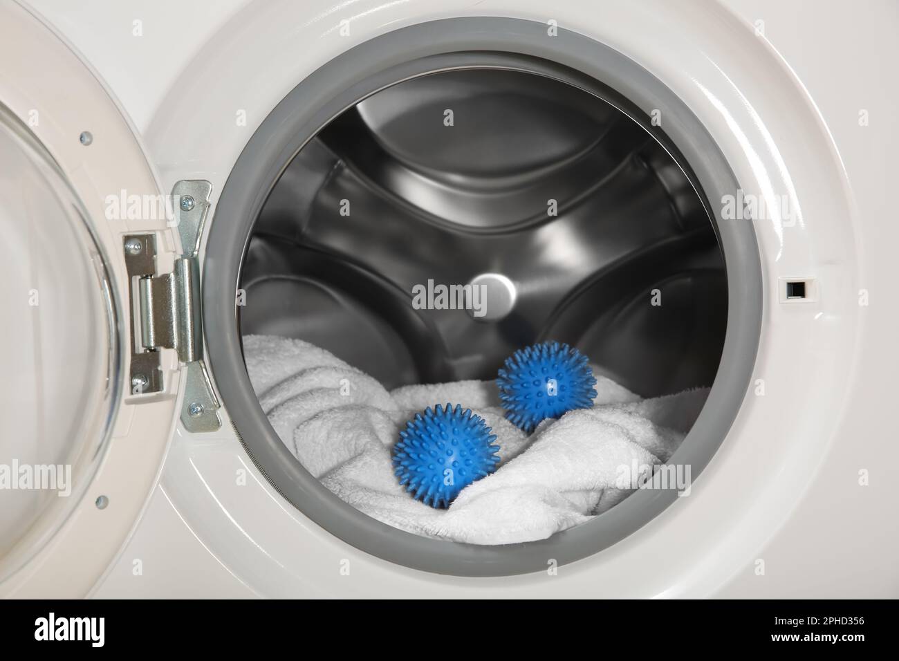 Blue dryer balls and towel in washing machine drum Stock Photo Alamy