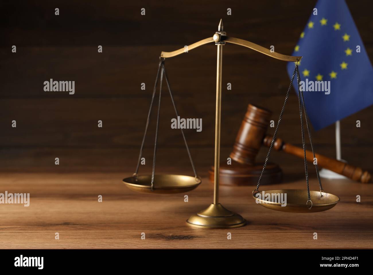 Scales of justice, judge's gavel and European Union flag on wooden ...