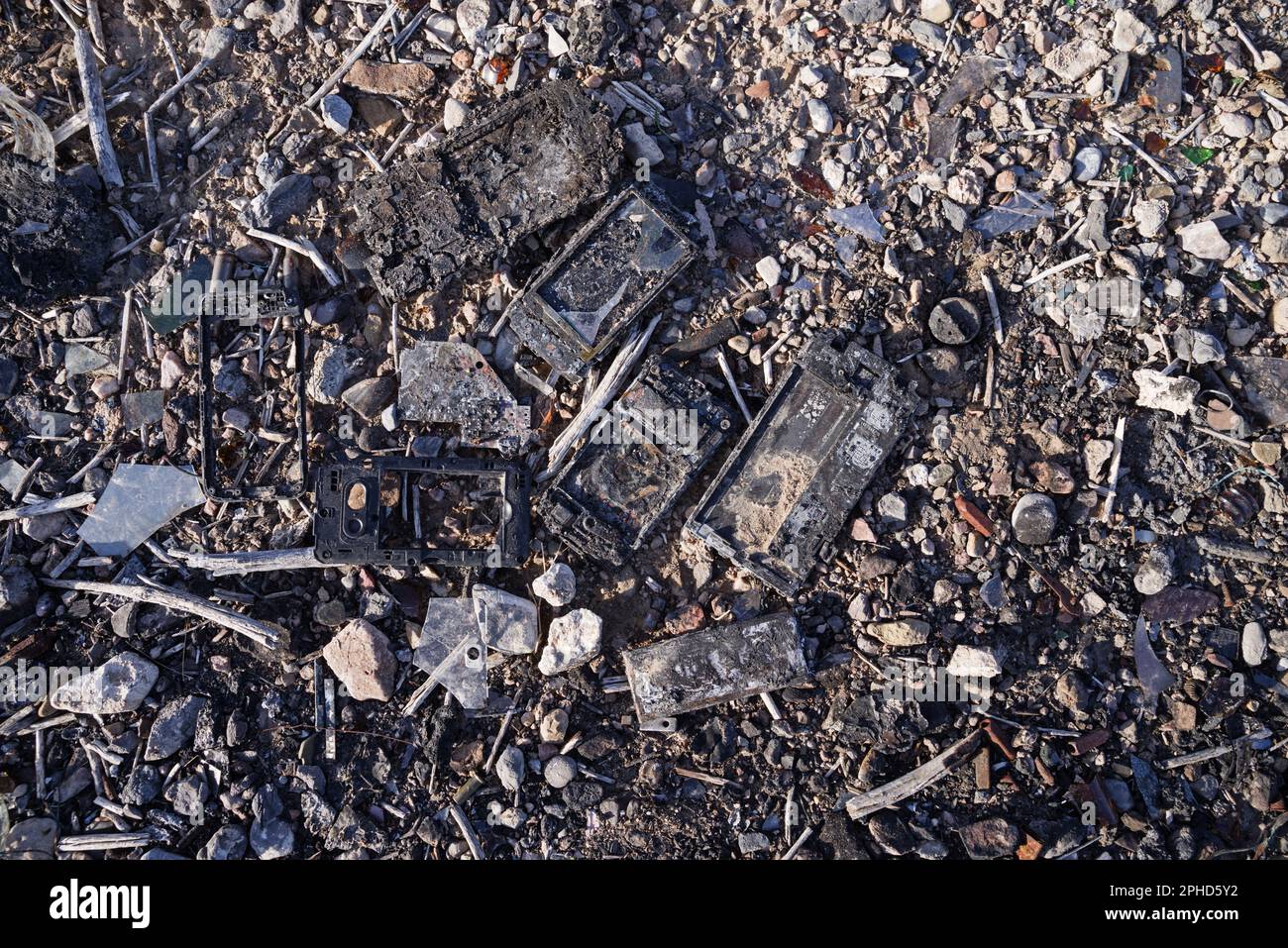 burned broken destroyed smart phones on the ground Stock Photo