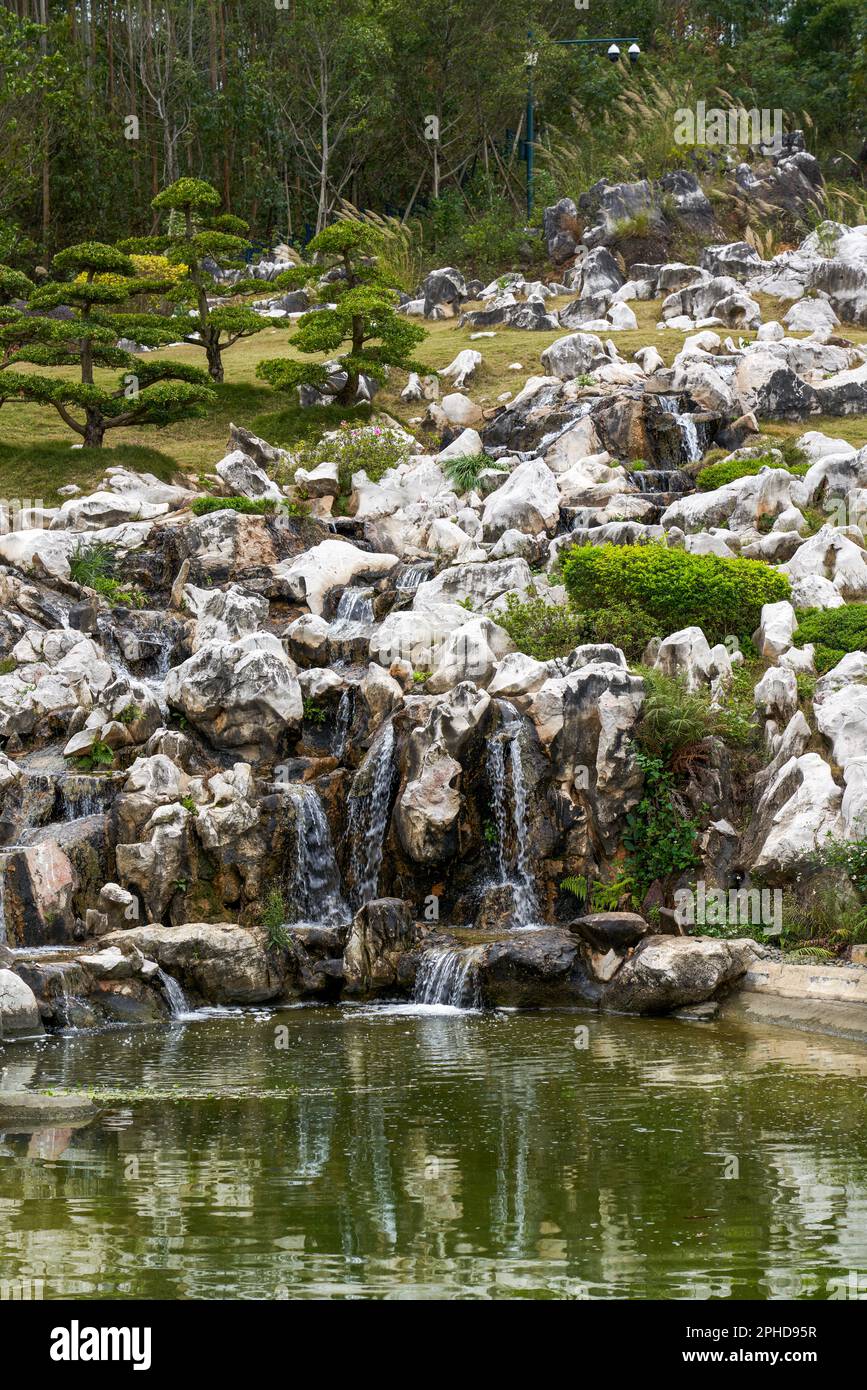 Rockery and pond in a beautiful garden Stock Photo - Alamy