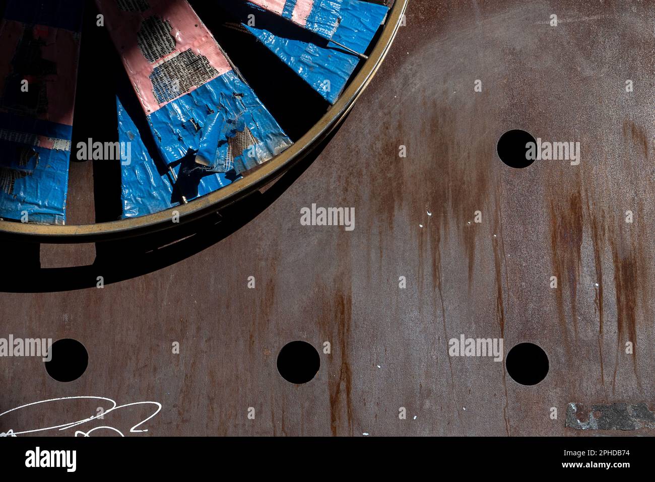 Downtown Seattle Alley with artistic wheel fixture and holes Stock ...
