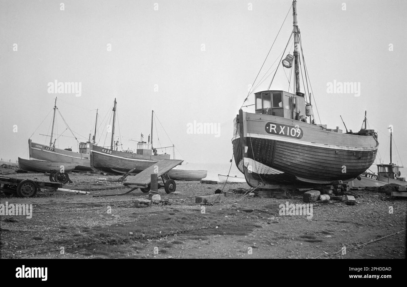 1960s photograph of boats on The Stade Beach in Hastings, England. Boats include RX109, RX88 Little Paul, RX77 Andina, RX60 St. Richard. Stock Photo