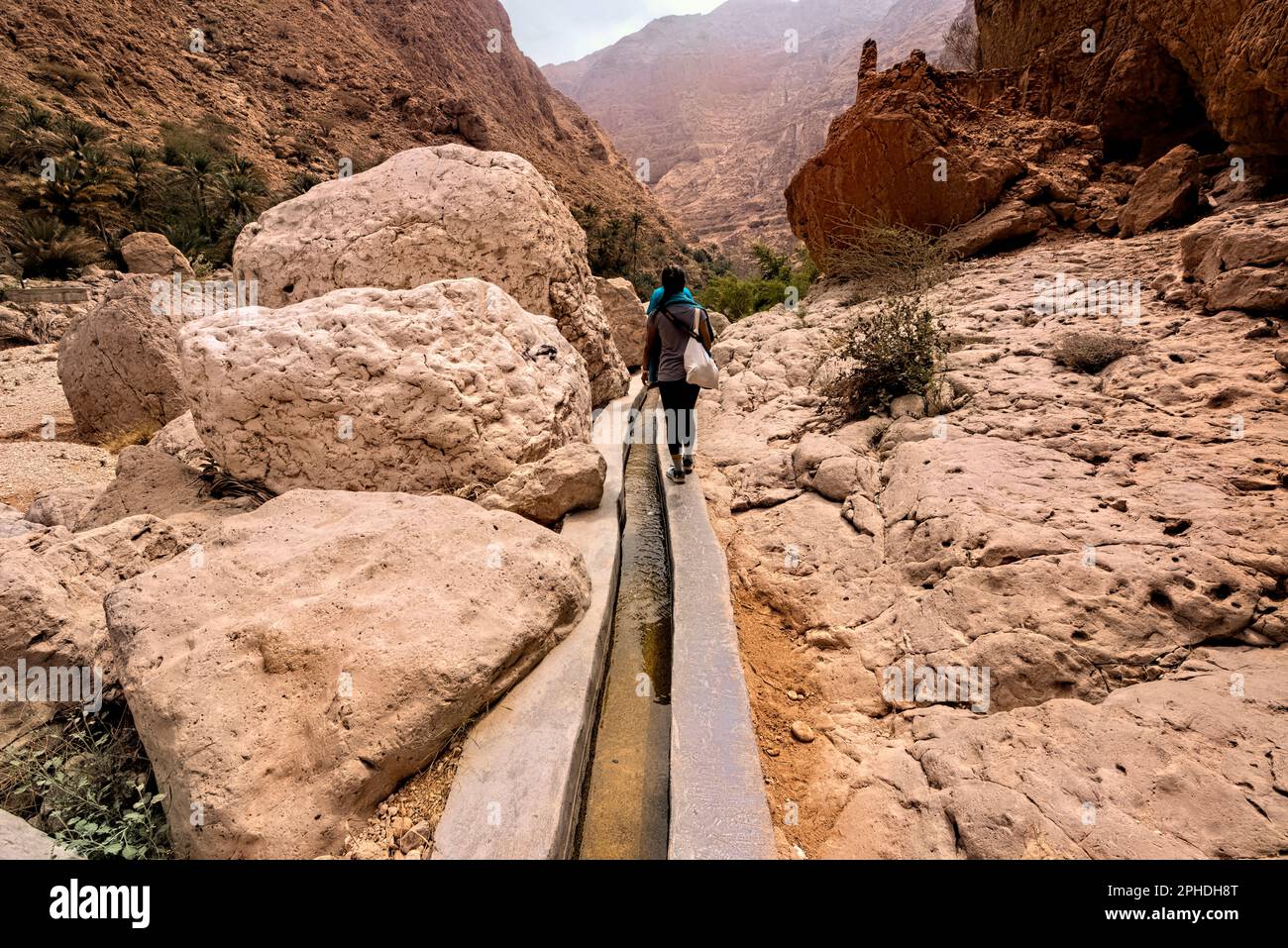 Hiker inside the beautiful Wadi Shab canyon, Wadi Ash Shab, Oman Stock