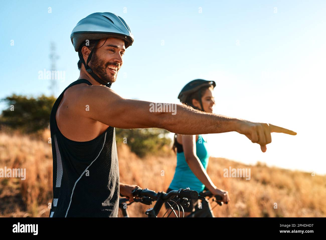 Mountain bikers breathe in fresh air, not pollution. a happy young
