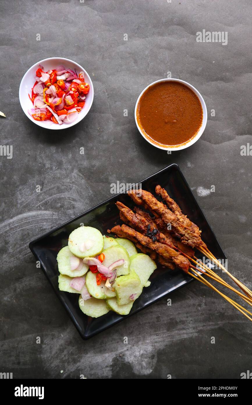 chicken satay or chicken satay served with lontong, rice cake and peanut sauce Stock Photo Alamy