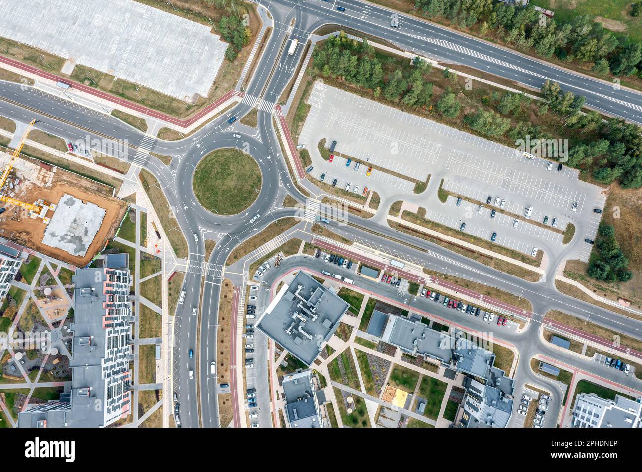roundabout circular intersection road and parking lots in city residential area. aerial top view. Stock Photo