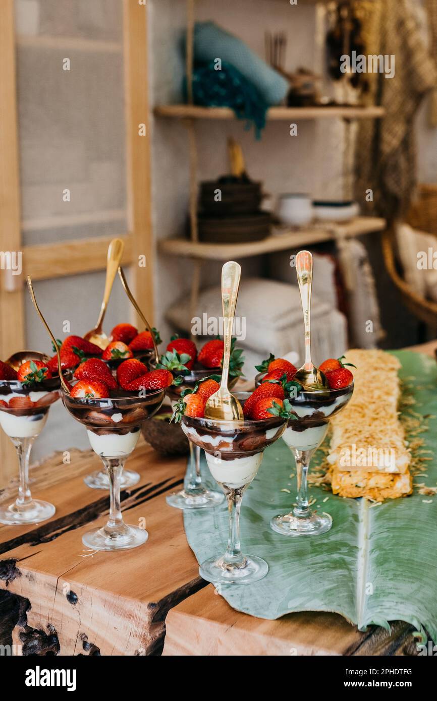 An array of delicious strawberry and chocolate covered desserts is displayed on a table in a festive setting Stock Photo