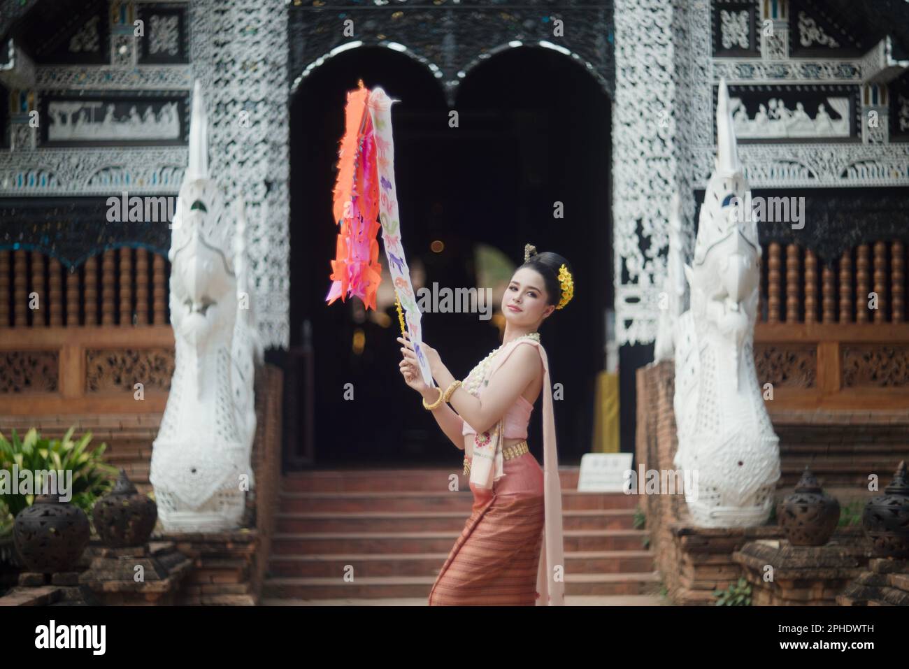 Asian women wearing traditional Thai dress to Buddha to make a wish on the  traditional Songkran festival in Thailand Stock Photo - Alamy
