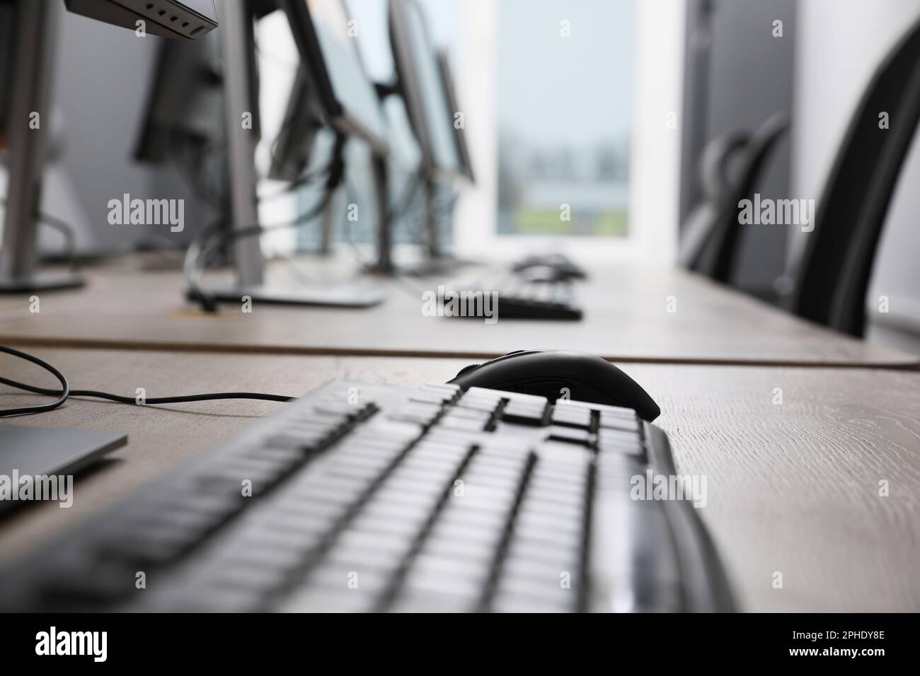 Many modern computers in open space office, focus on keyboard Stock Photo