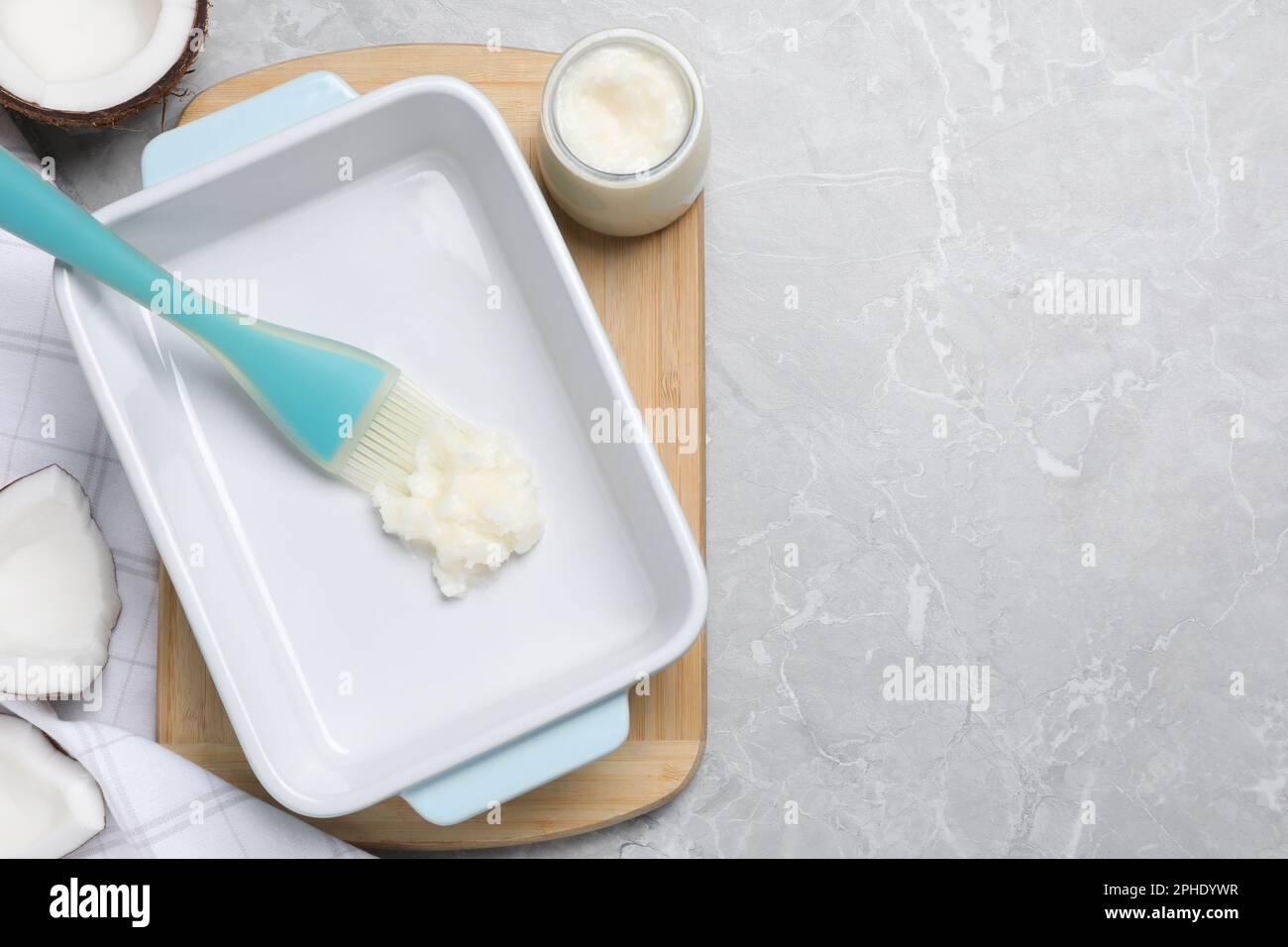 https://c8.alamy.com/comp/2PHDYWR/baking-dish-with-coconut-oil-and-silicone-brush-on-light-grey-table-flat-lay-space-for-text-2PHDYWR.jpg