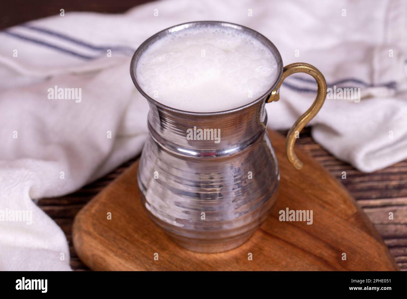 Buttermilk. Sparkling buttermilk in an iron glass. Beverage prepared with yogurt and water
