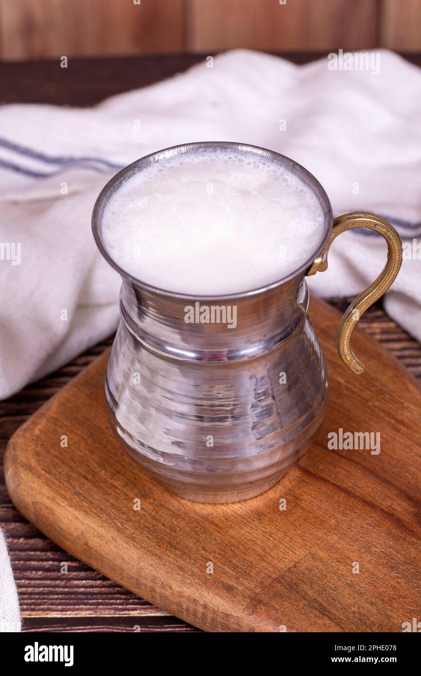 Buttermilk. Sparkling buttermilk in an iron glass. Beverage prepared