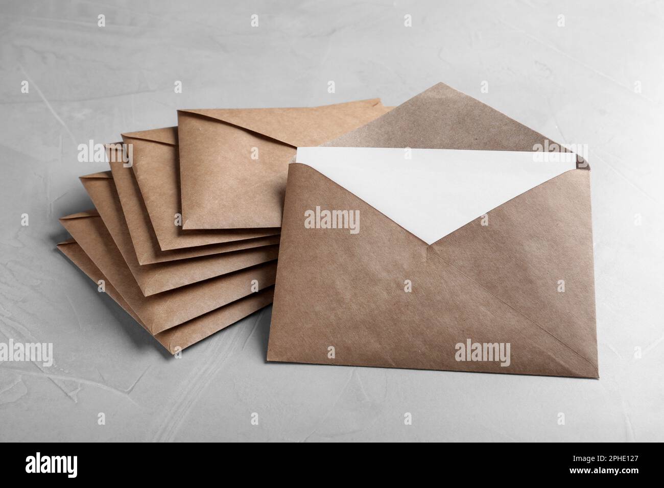 Many brown paper envelopes on light grey table Stock Photo