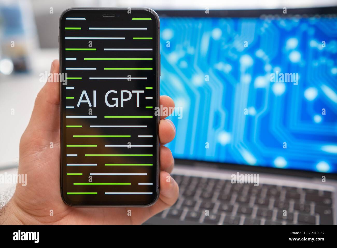 AI GPT logo of neural network on the screen of smartphone in mans hand and laptop with neuronet on the splash screen on the background. Artificial intelligence concept. March 2023, Prague, Czech Republic.  Stock Photo