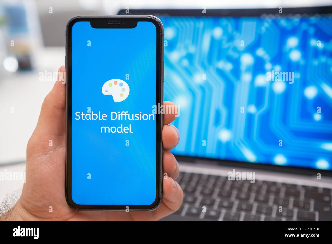 Stable Diffusion model artificial intelligence logo on the screen of mobile phone and neural network on the screen of laptop on the background, March 2023, Prague, Czech Republic. Stock Photo