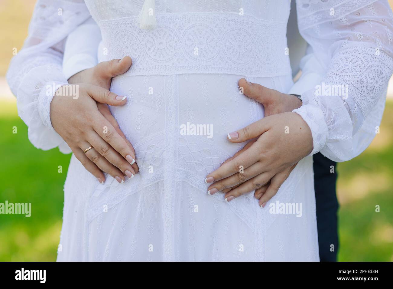 The man holds the woman's hand. The guy hugs the girl Stock Photo - Alamy