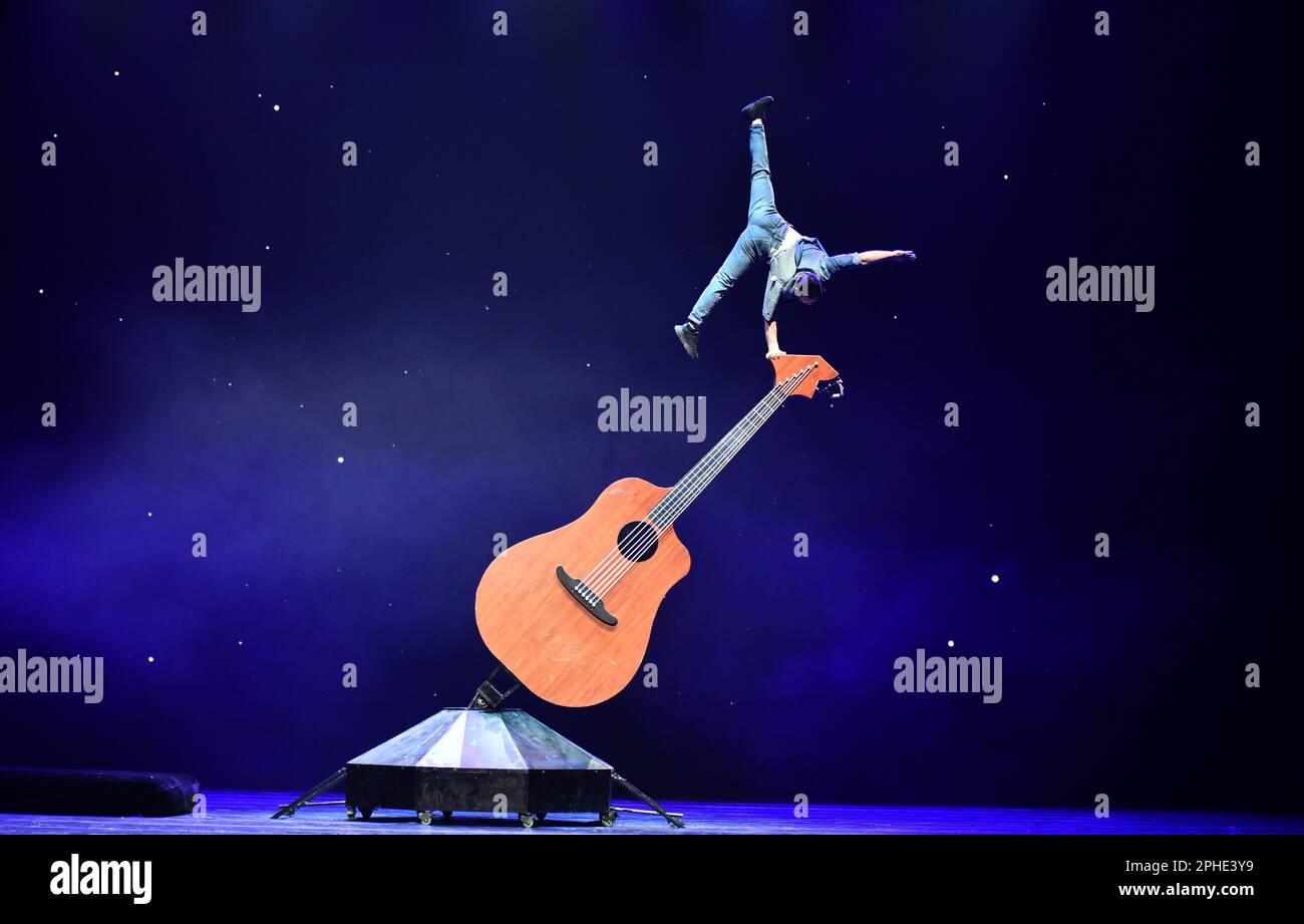 Jinan, China's Shandong Province. 27th Mar, 2023. An actor performs acrobatics on stage during the gala show of the 11th China Acrobatic Exhibition in Jinan, east China's Shandong Province, March 27, 2023. The 11th China Acrobatic Exhibition has been held from March 16 to 29 in Shandong. This year's event features a series of acrobatic and magic shows as well as acrobatic dramas. Credit: Xu Suhui/Xinhua/Alamy Live News Stock Photo