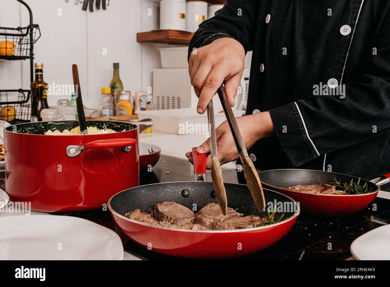 A professional chef is preparing a variety of dishes in a commercial ...
