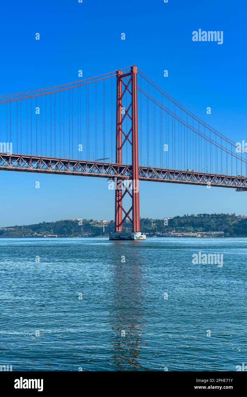 The Ponte 25 de Abril suspension bridge connects Lisbon to Almada over the Tagus River. The top deck is for road traffic, the lower deck for trains. Stock Photo