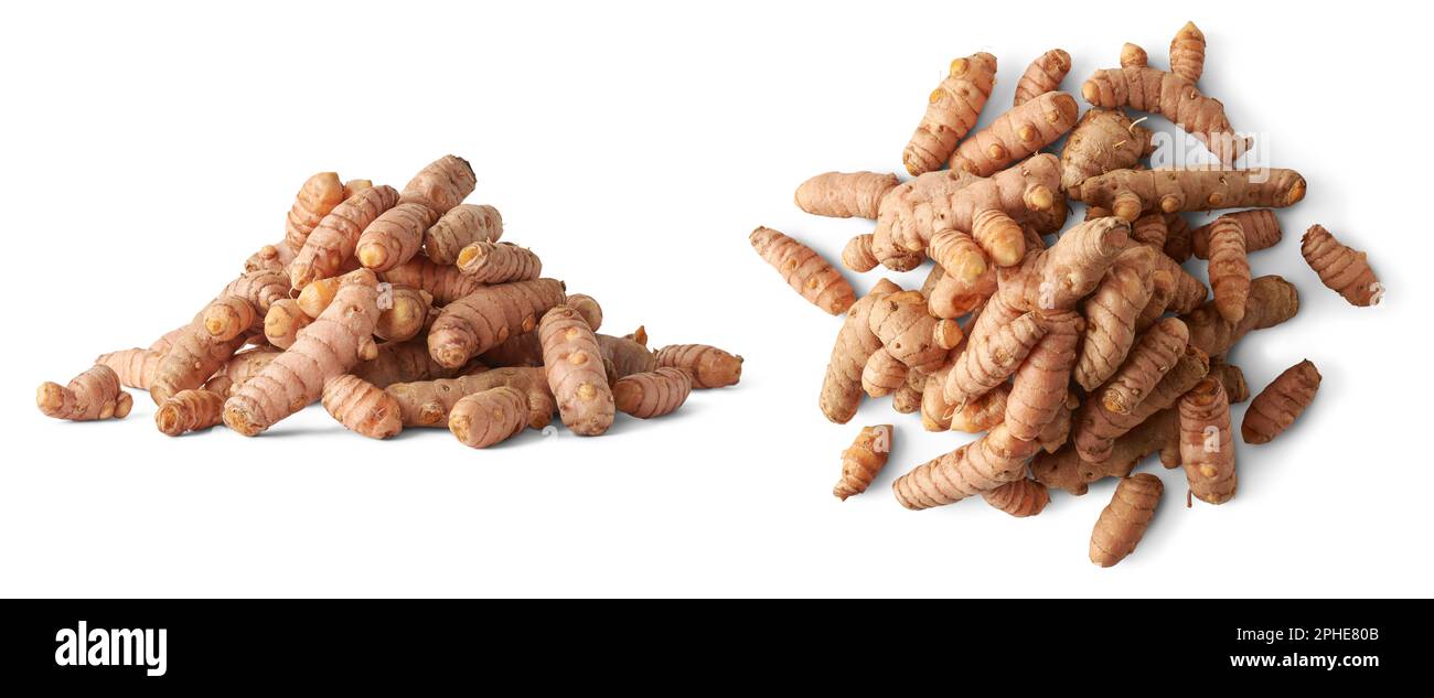 pile of cleaned turmeric rhizomes or roots isolated on white background