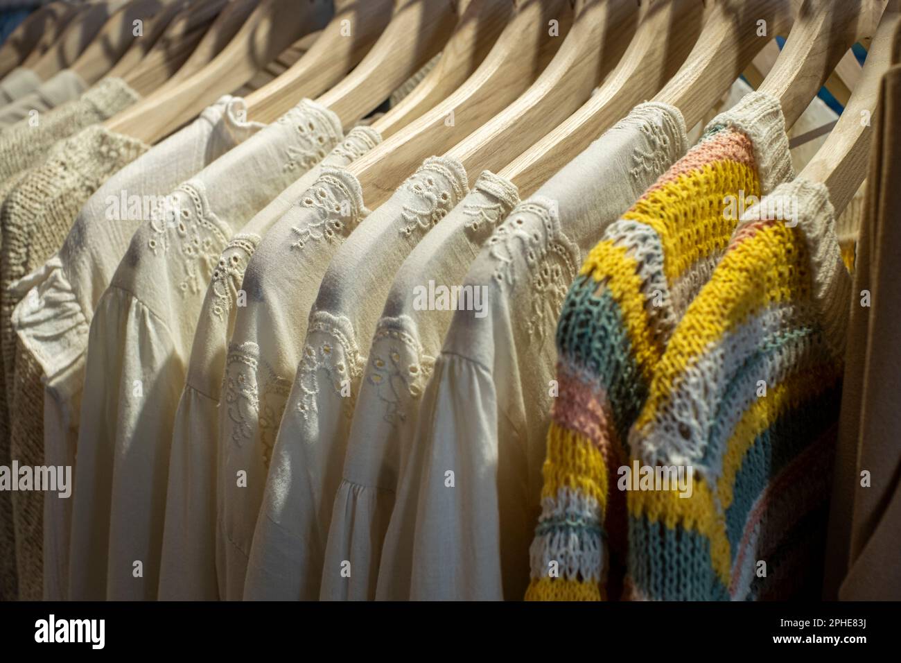 https://c8.alamy.com/comp/2PHE83J/spring-garments-hanging-on-hangers-in-a-store-selective-focus-2PHE83J.jpg