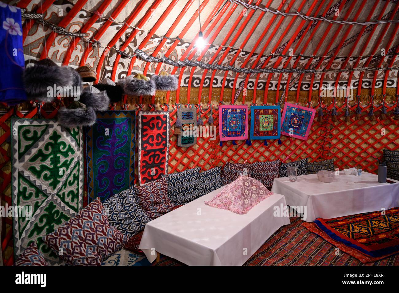 Interior decoration of the traditional national Kyrgyz yurt with tables for guests Stock Photo