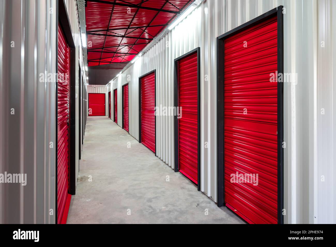 Corridor of self storage unit with red doors. Rental Storage Units