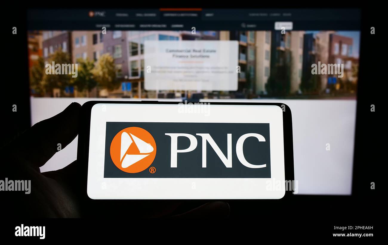 Person holding smartphone with logo of US company PNC Financial Service