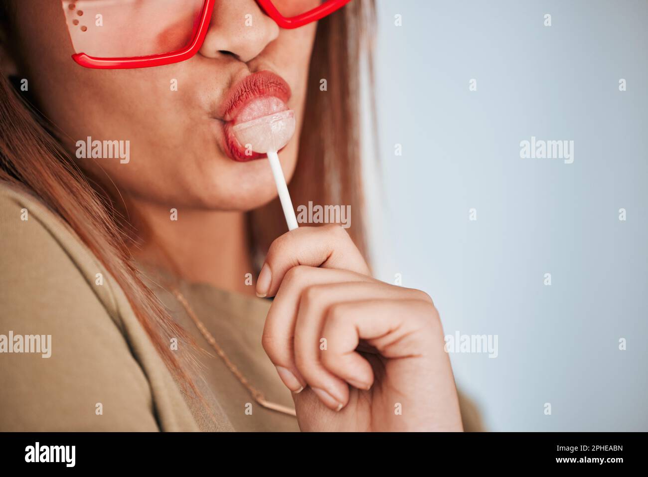 Lollipop, woman closeup and mouth with makeup, cosmetics and gen z