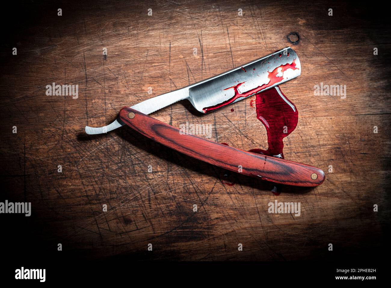 Bloody razor on wooden background Stock Photo