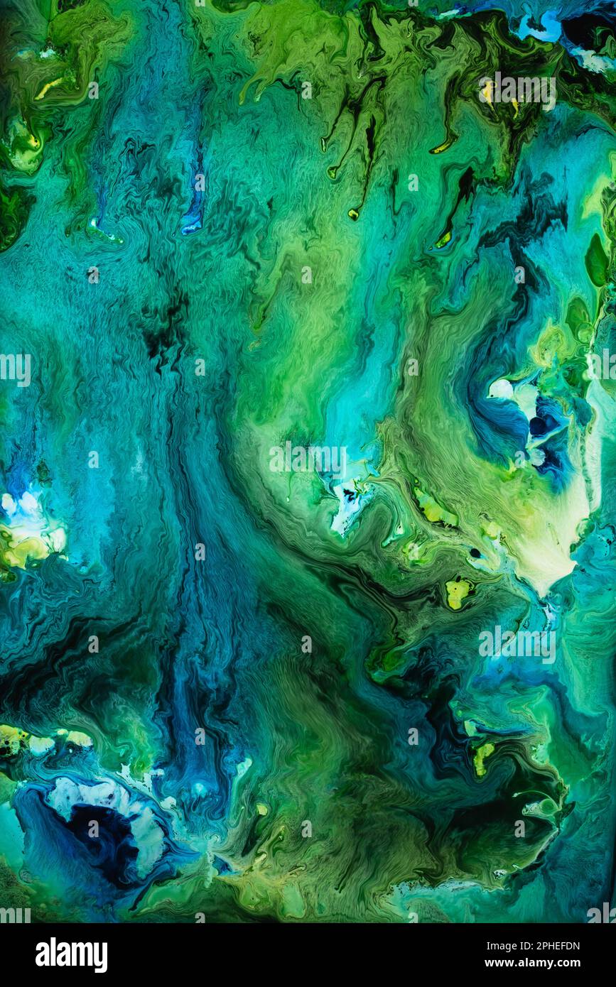Beautiful abstraction of liquid paints in slow blending flow mixing together gently Stock Photo