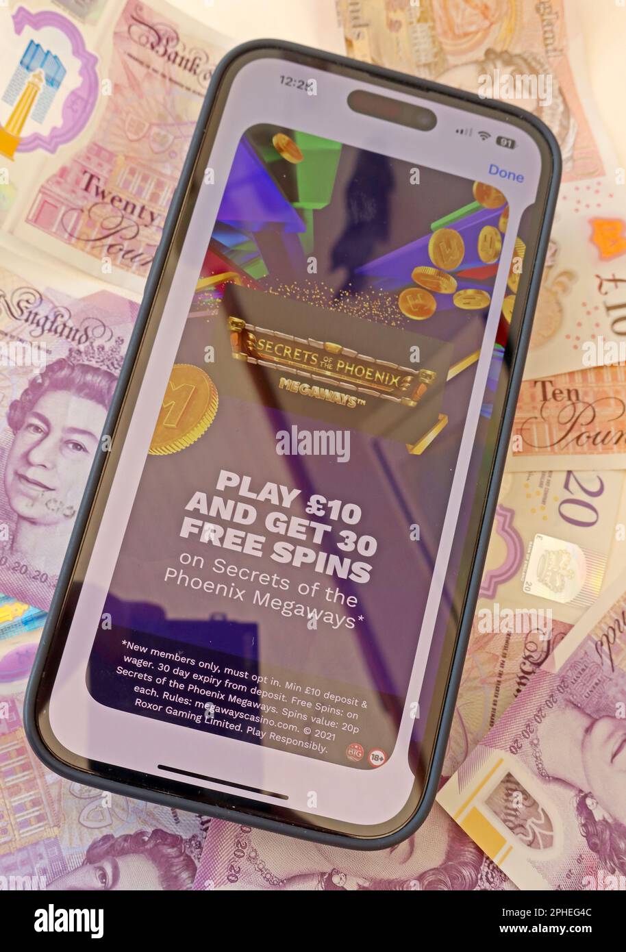Tempting Free Spins - Online and smartphone casino, slots and gambling app with English Sterling notes, money easily lost - BeGambleAware Stock Photo