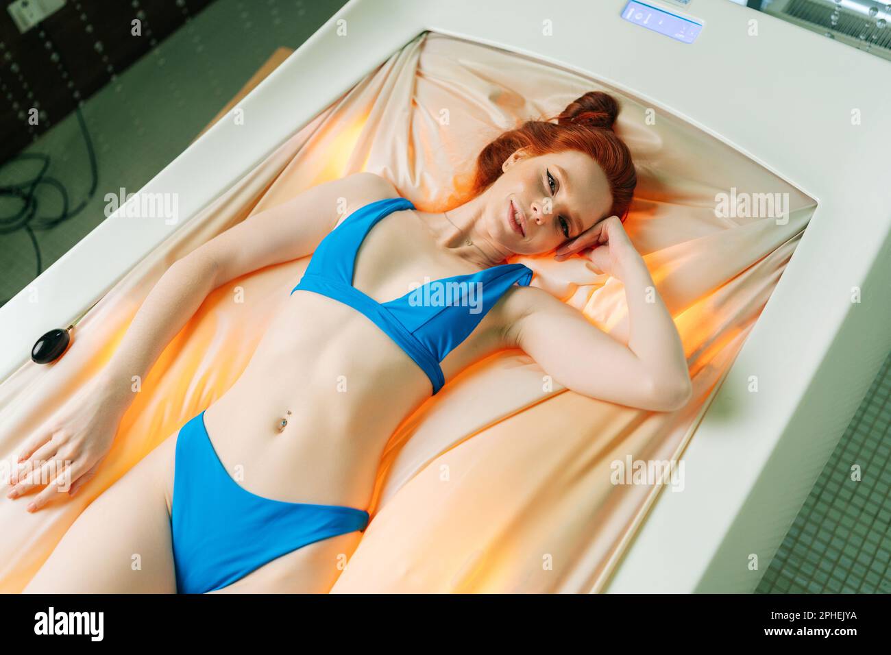 Young girl wearing bikini lying hi-res stock photography and
