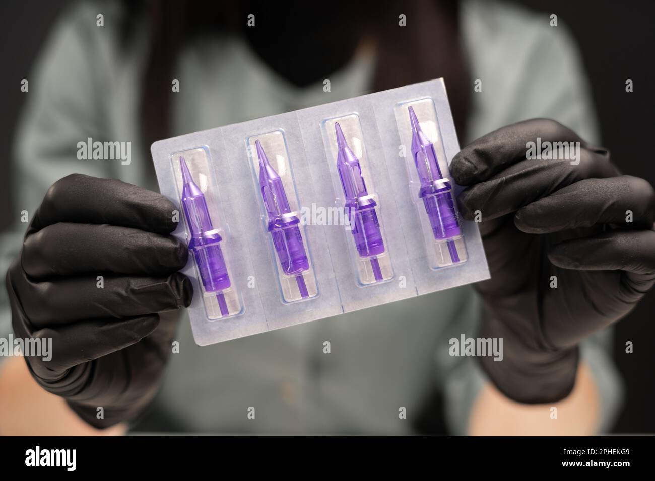 Permanent makeup tools in female hands. Needles, permanent makeup, lips ...