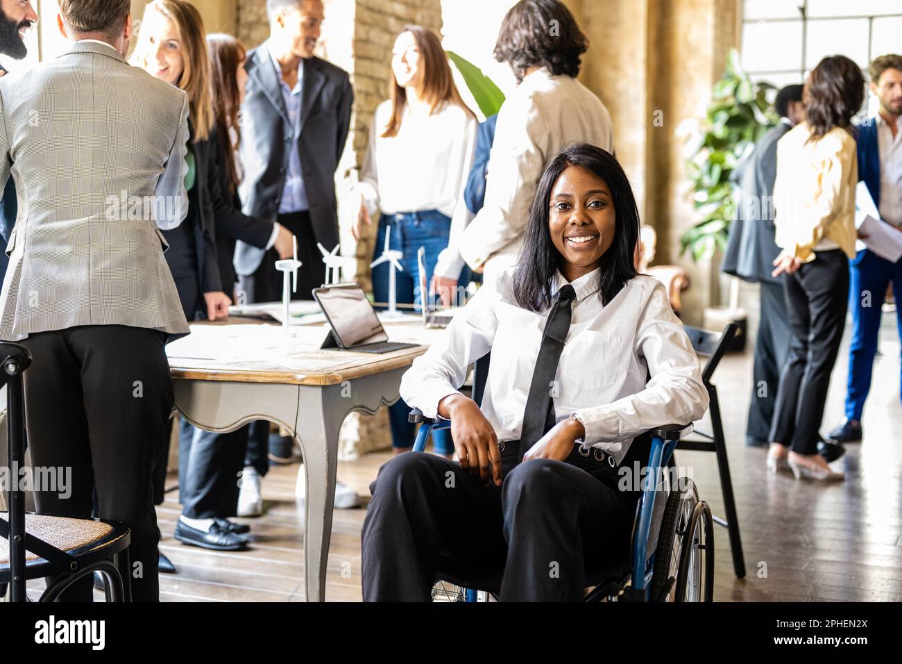 Young African American business woman on wheelchair smiling and looking at the camera, diversity and social inclusion concept, working to solve enviro Stock Photo