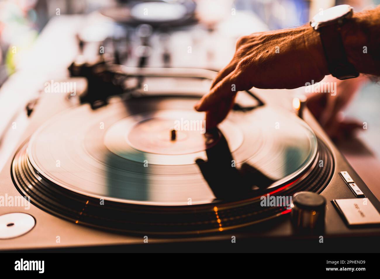 Dj hands on equipment deck and mixer with vinyl record at party, human