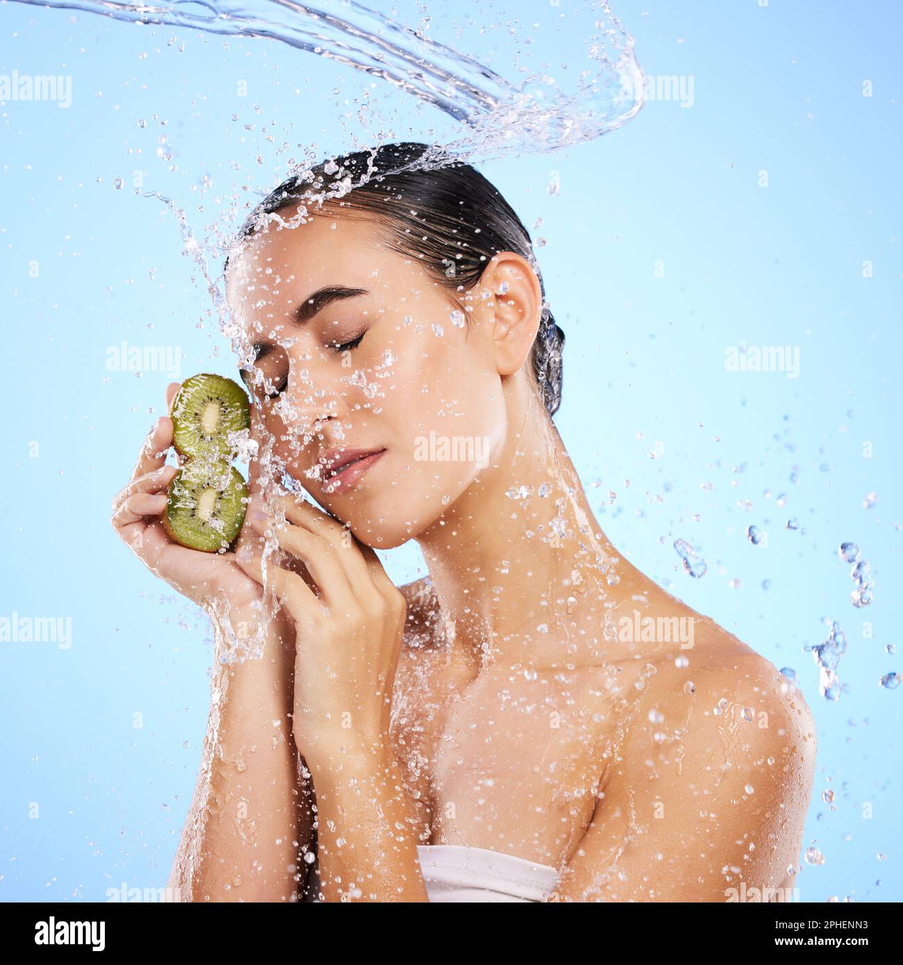 Kiwi, skincare and water splash of woman, beauty and wellness on studio ...
