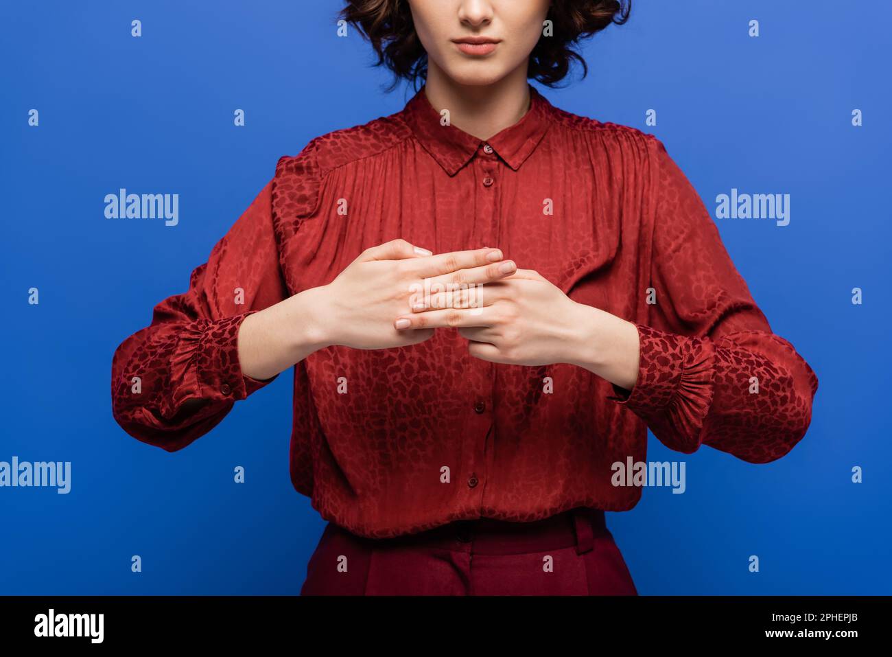 cropped view of teacher showing name word with hands while teaching how to use sign language isolated on blue,stock image Stock Photo