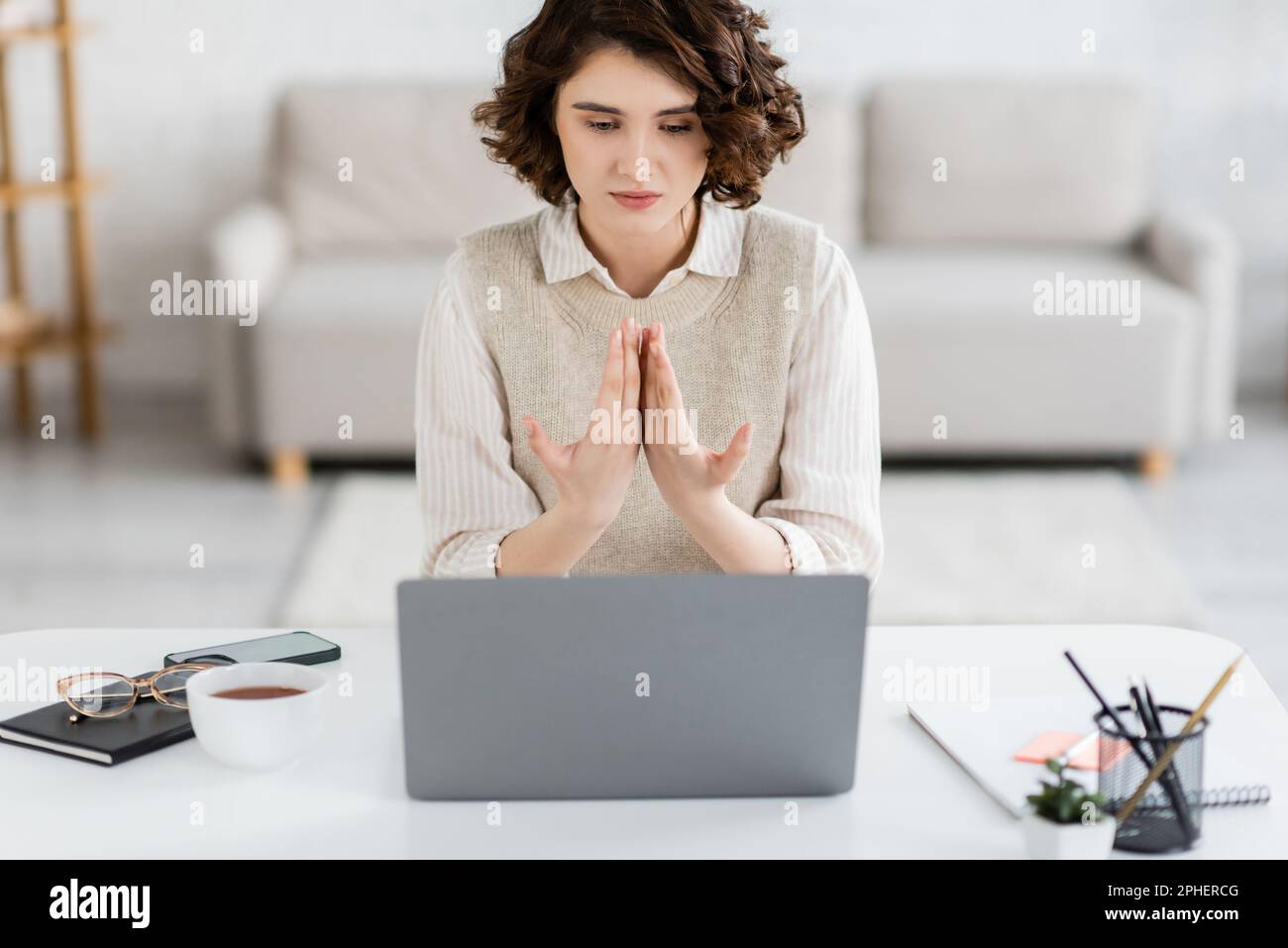 young sign language teacher with curly hair communicating during lesson