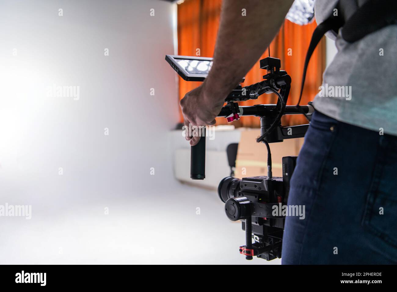 The cameraman in the studio using a professional camera with a stabilizer Stock Photo