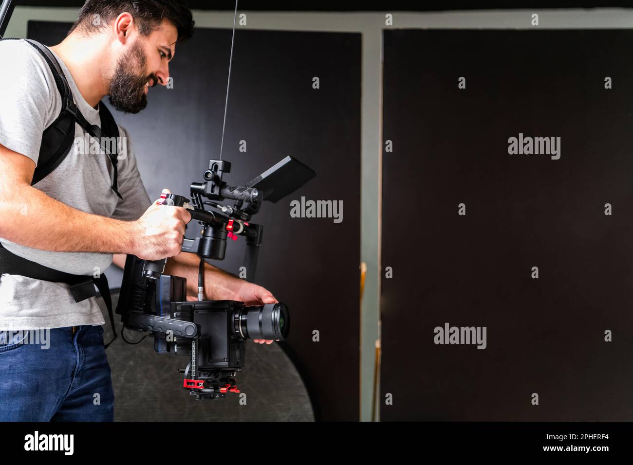 The cameraman in the studio using a professional camera with a ...