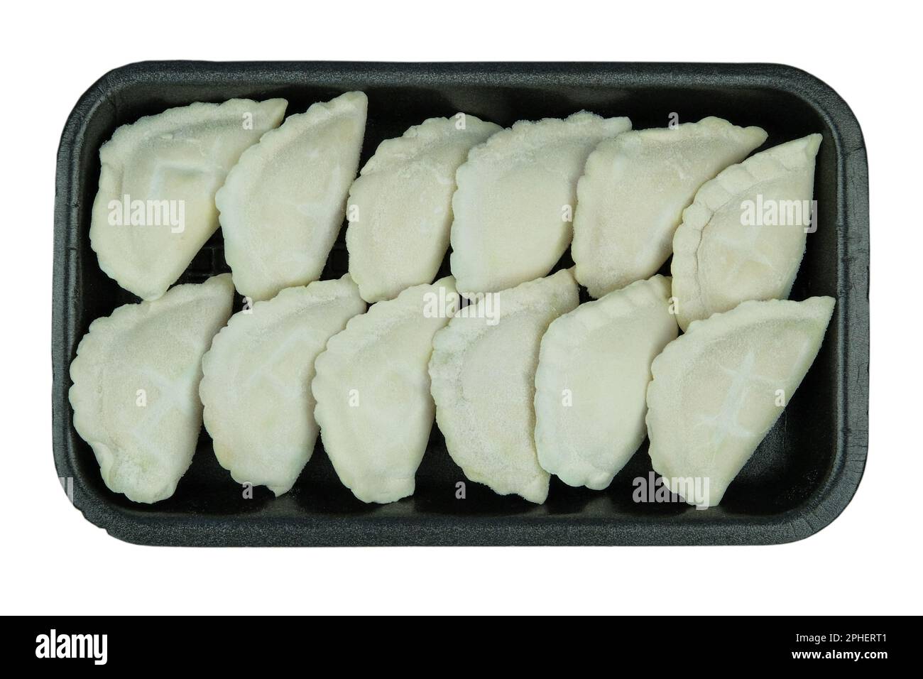 Raw Vareniks with potato filling on a board on a white background. Traditional Ukrainian cuisine. Horizontal orientation. Top view. Stock Photo