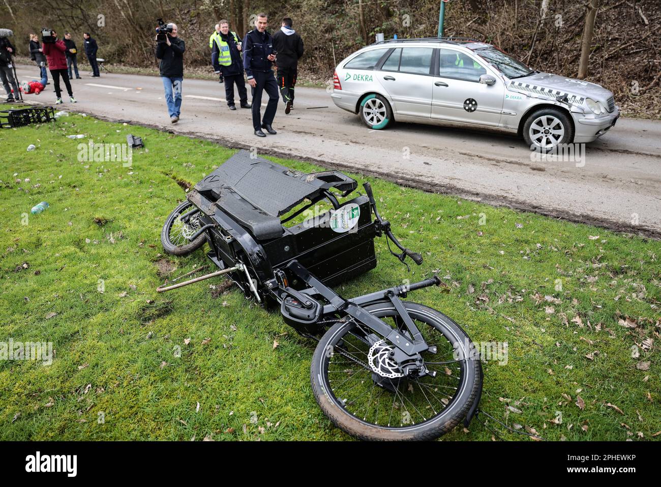 Essen, Germany. 28th Mar, 2023. After a crash test simulating a collision  with a car, a damaged cargo bike lies on the lawn. At the presentation of a  campaign for responsible use